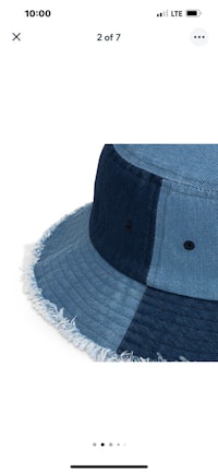 a denim bucket hat with fringes on it